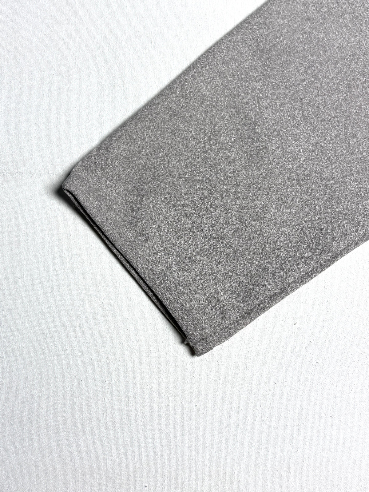 Minimalist Taupe Split-Neck Blouse with Curved Hem & Long Sleeves