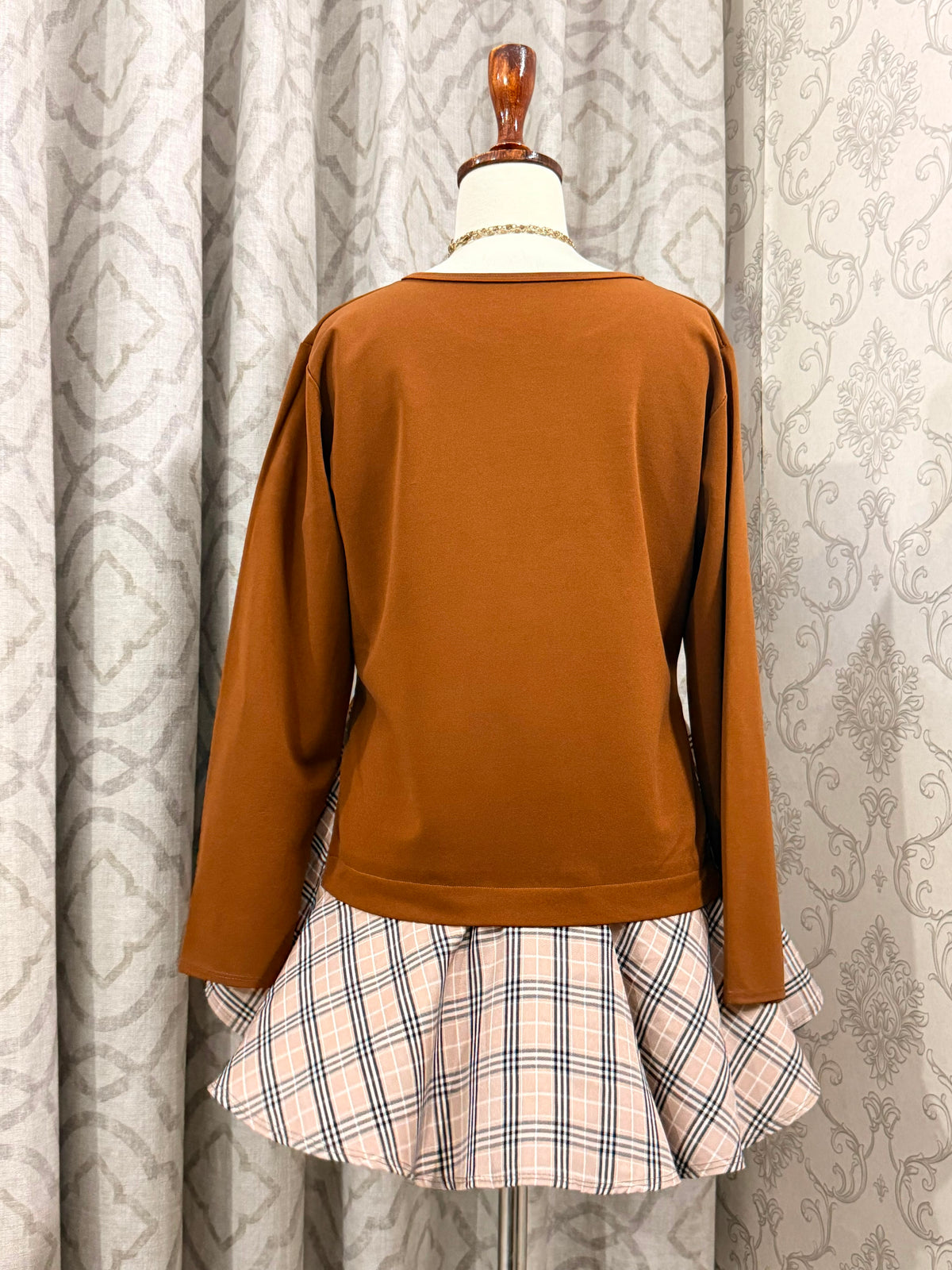 Chic Terracotta Crewneck Top with Plaid Contrast Flare Hem