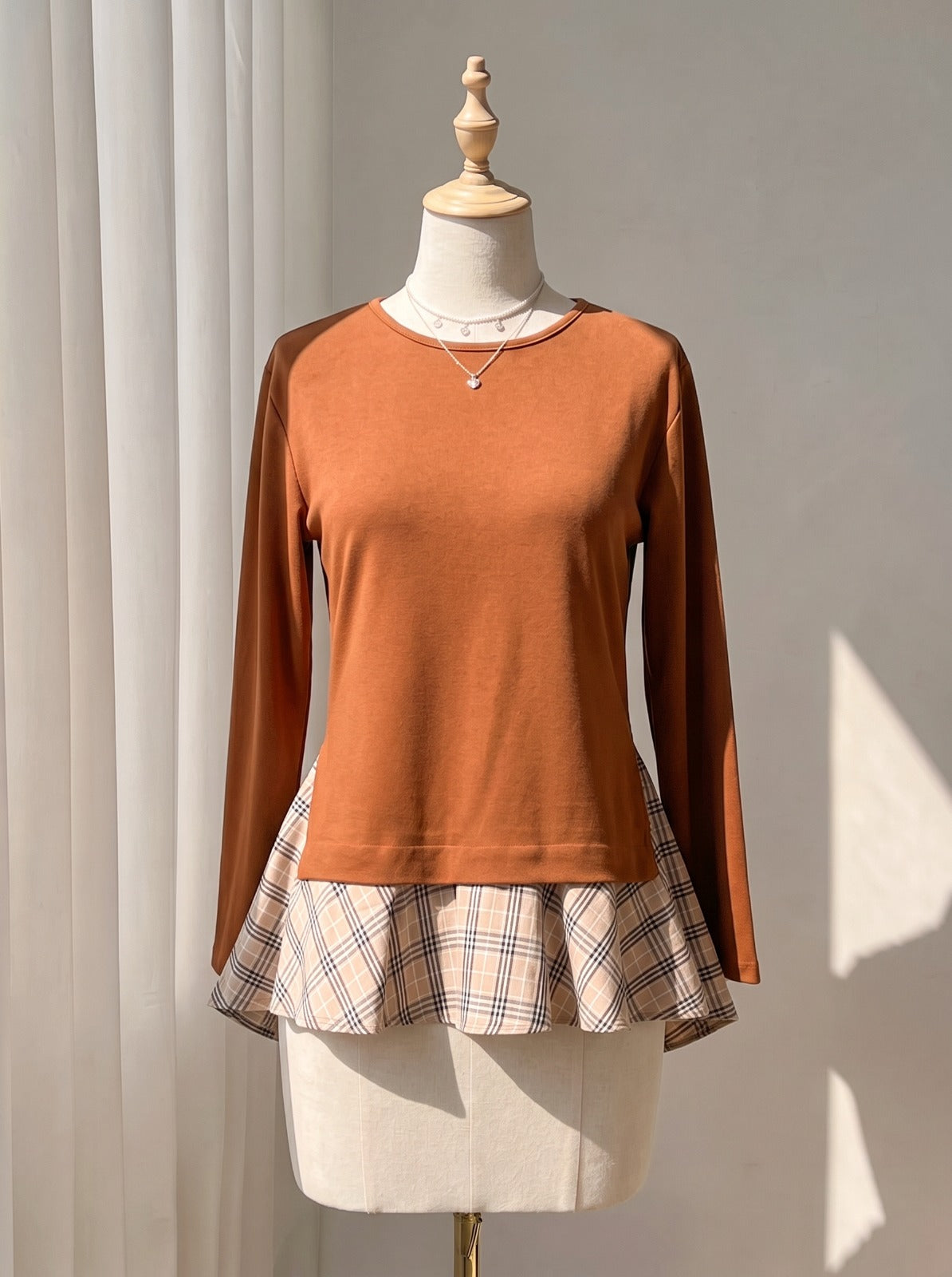 Chic Terracotta Crewneck Top with Plaid Contrast Flare Hem