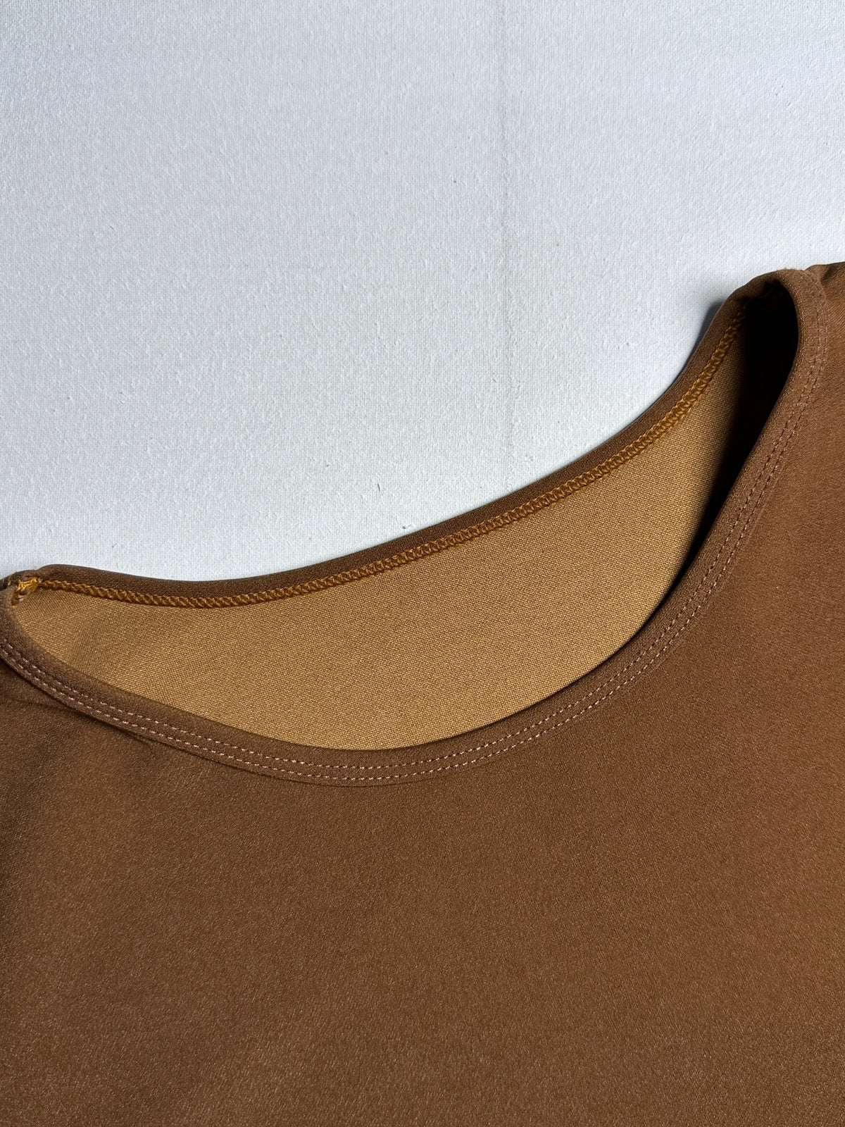 Chic Terracotta Crewneck Top with Plaid Contrast Flare Hem
